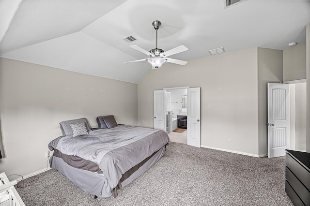 carpeted bedroom with lofted ceiling, visible vents, ensuite bath, and baseboards