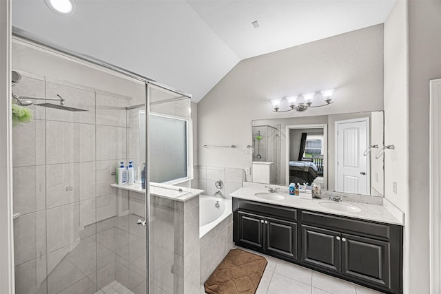 bathroom with lofted ceiling, ensuite bath, tile patterned floors, a garden tub, and a sink