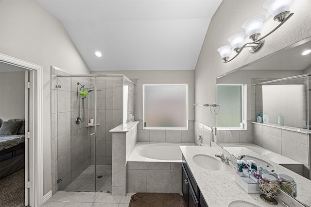 full bathroom featuring a stall shower, vaulted ceiling, a sink, tile patterned flooring, and a bath