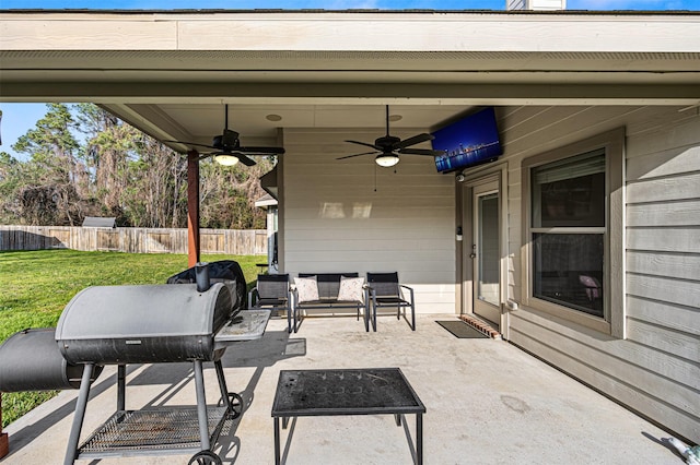 view of patio featuring ceiling fan and fence