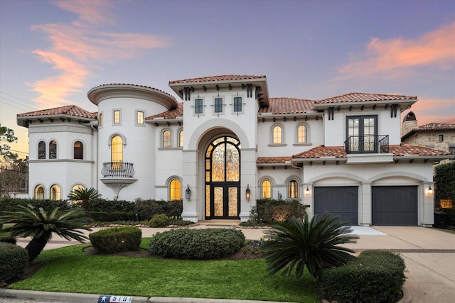 mediterranean / spanish-style house with french doors and a garage