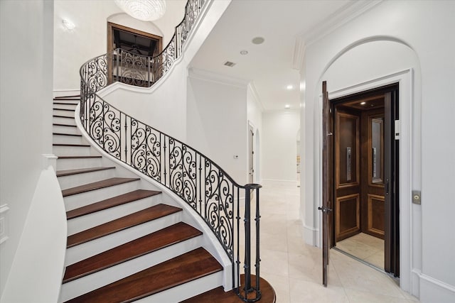 stairs featuring crown molding and tile patterned floors