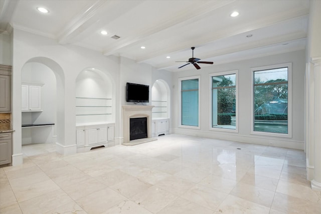 unfurnished living room with built in features, ornamental molding, ceiling fan, and beam ceiling