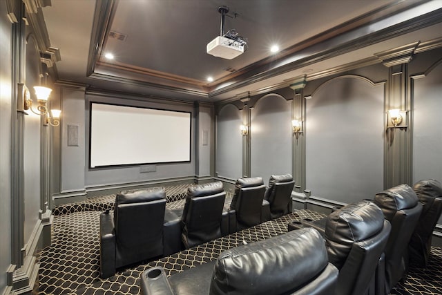 home theater featuring dark carpet, a tray ceiling, and crown molding