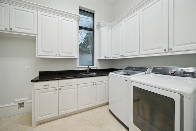 laundry room with sink, cabinets, and independent washer and dryer