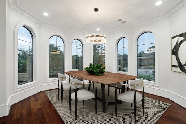 dining room featuring crown molding, a wealth of natural light, dark hardwood / wood-style flooring, and a notable chandelier