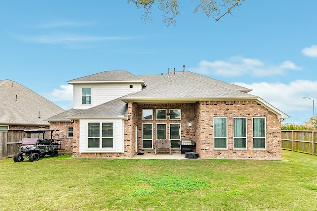 rear view of property featuring a patio and a lawn