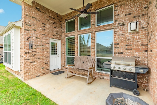 view of patio / terrace with area for grilling, ceiling fan, and an outdoor fire pit