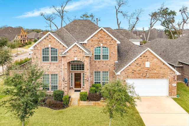 view of front of house featuring a garage and a front yard