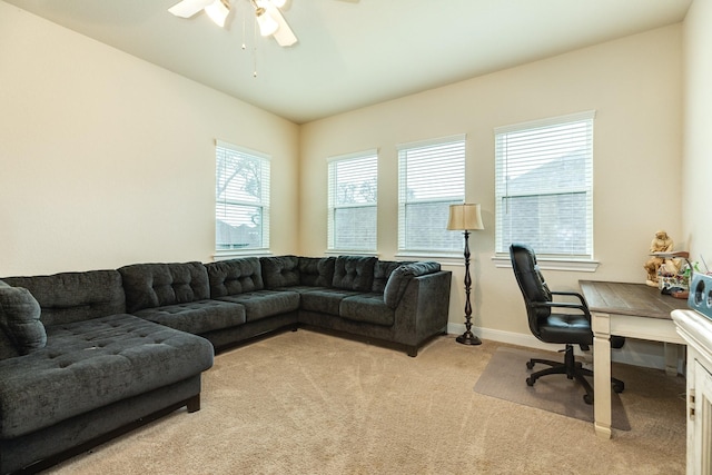 carpeted office featuring ceiling fan