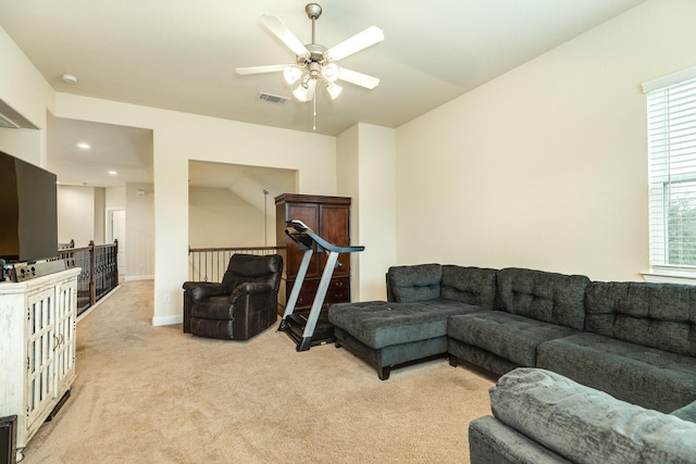 carpeted living room with ceiling fan