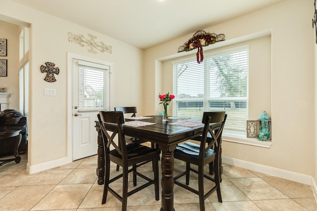 dining space with light tile patterned floors and a wealth of natural light