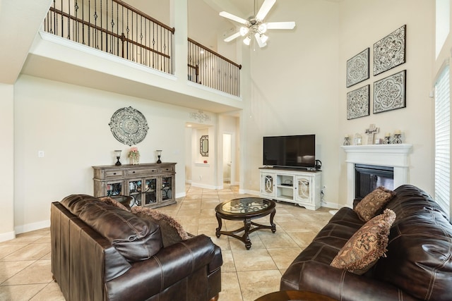 living room featuring light tile patterned floors and ceiling fan