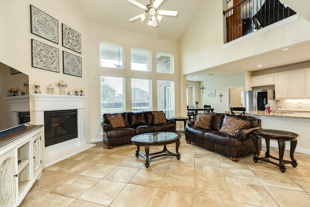 tiled living room with ceiling fan