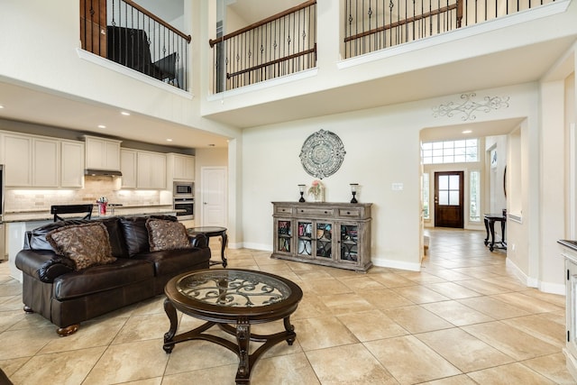 tiled living room featuring a high ceiling