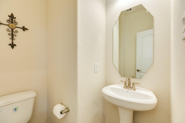 bathroom featuring sink and toilet