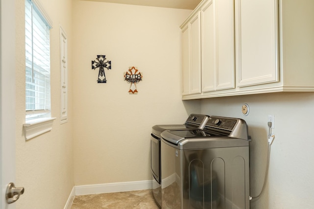 laundry room featuring washing machine and dryer and cabinets