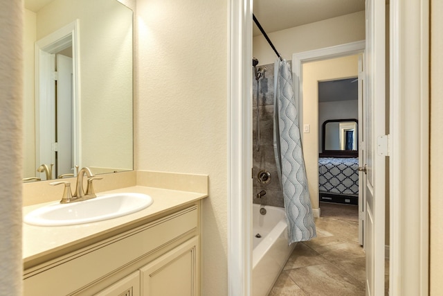 bathroom with tile patterned floors, shower / bathtub combination with curtain, and vanity