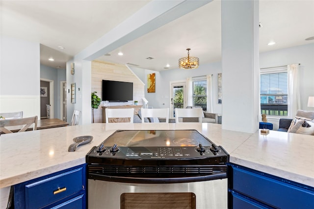 kitchen with stainless steel range with electric cooktop, an inviting chandelier, and blue cabinetry