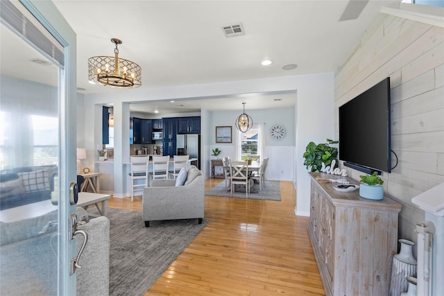 living room featuring a chandelier and light hardwood / wood-style floors