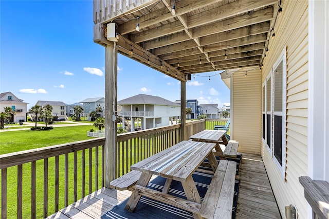 wooden terrace featuring a lawn