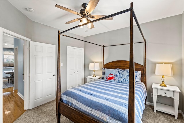 carpeted bedroom featuring ceiling fan and a closet