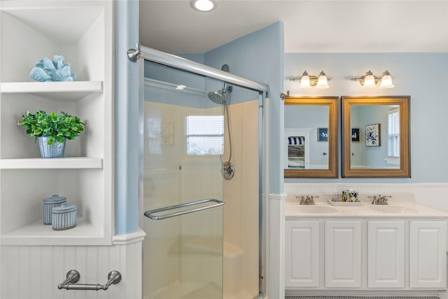 bathroom with vanity, built in shelves, and walk in shower