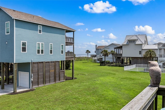 view of yard with a garage and a balcony