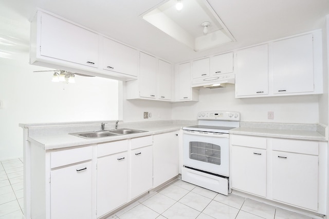 kitchen with electric stove, light tile patterned flooring, a raised ceiling, sink, and white cabinetry