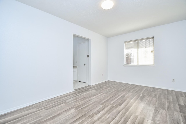 spare room with light hardwood / wood-style flooring