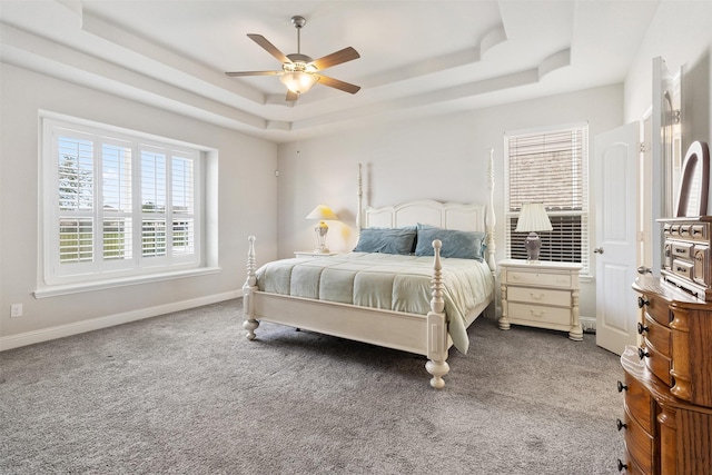 bedroom featuring carpet floors, ceiling fan, and a raised ceiling