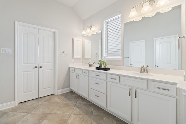 bathroom with vanity and lofted ceiling