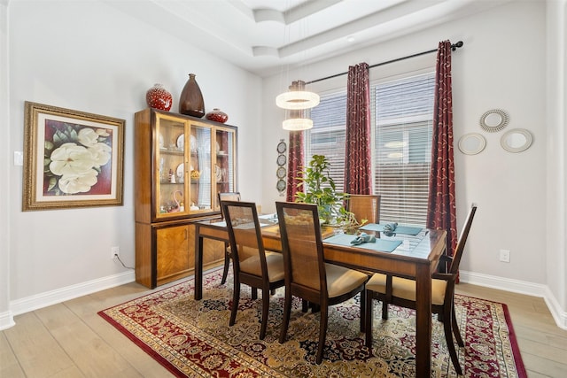 dining space with light hardwood / wood-style floors