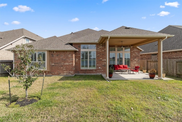 back of property with a yard, outdoor lounge area, and a patio area