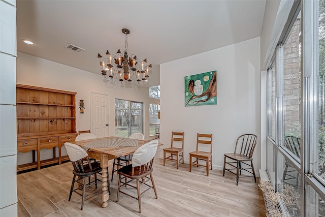 dining room featuring a notable chandelier and light hardwood / wood-style floors