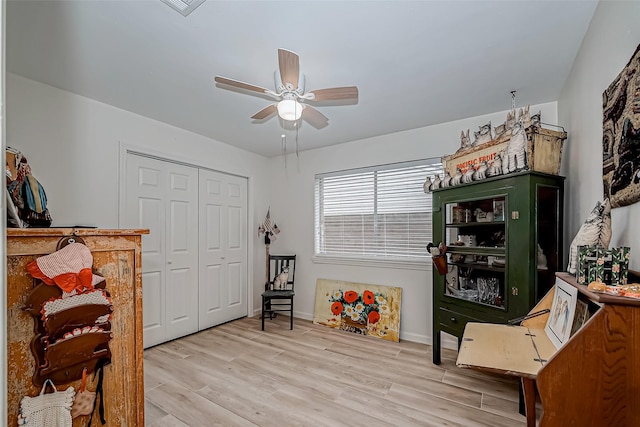 interior space with ceiling fan and light hardwood / wood-style flooring