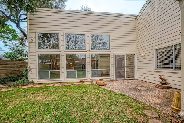 rear view of house with a yard