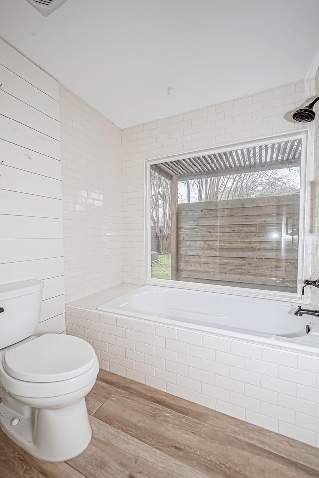 bathroom featuring hardwood / wood-style flooring and toilet