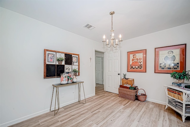 interior space with an inviting chandelier and light hardwood / wood-style floors