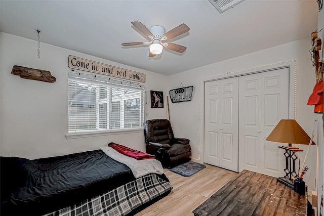 bedroom featuring a closet, hardwood / wood-style flooring, and ceiling fan