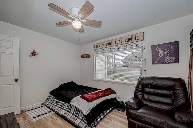 bedroom with ceiling fan and light hardwood / wood-style floors