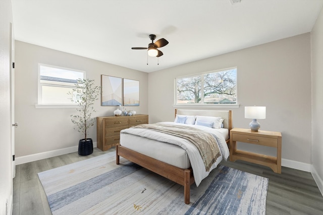 bedroom featuring a ceiling fan, baseboards, and wood finished floors