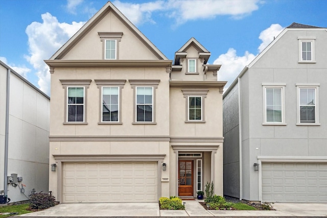 view of front of home with driveway, an attached garage, and stucco siding