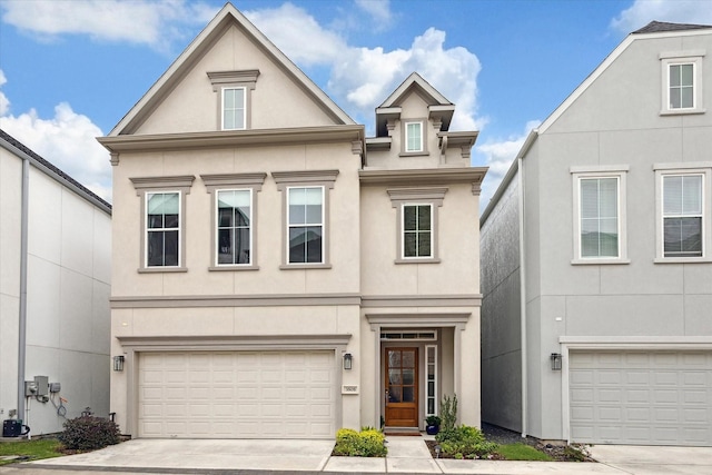 view of front of property featuring a garage, driveway, and stucco siding