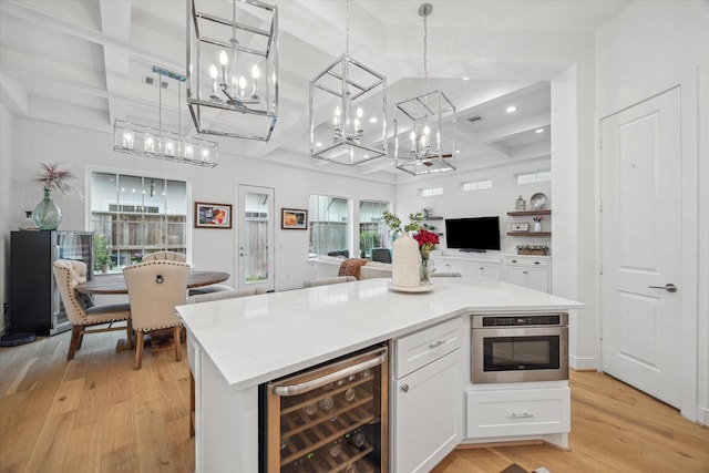 kitchen with white cabinets, wine cooler, coffered ceiling, and open floor plan