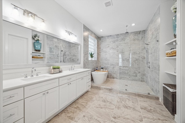 full bath with a walk in shower, a sink, and visible vents