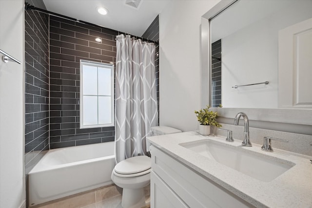 full bath featuring tile patterned flooring, toilet, visible vents, vanity, and shower / bath combo with shower curtain