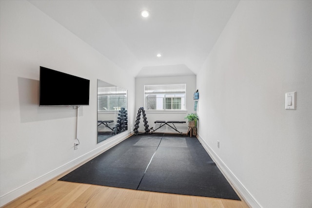 exercise area with baseboards, wood finished floors, and recessed lighting