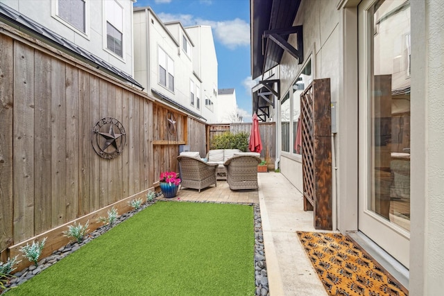 view of yard with fence private yard, a patio area, and outdoor lounge area