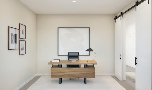 office area with baseboards and a barn door